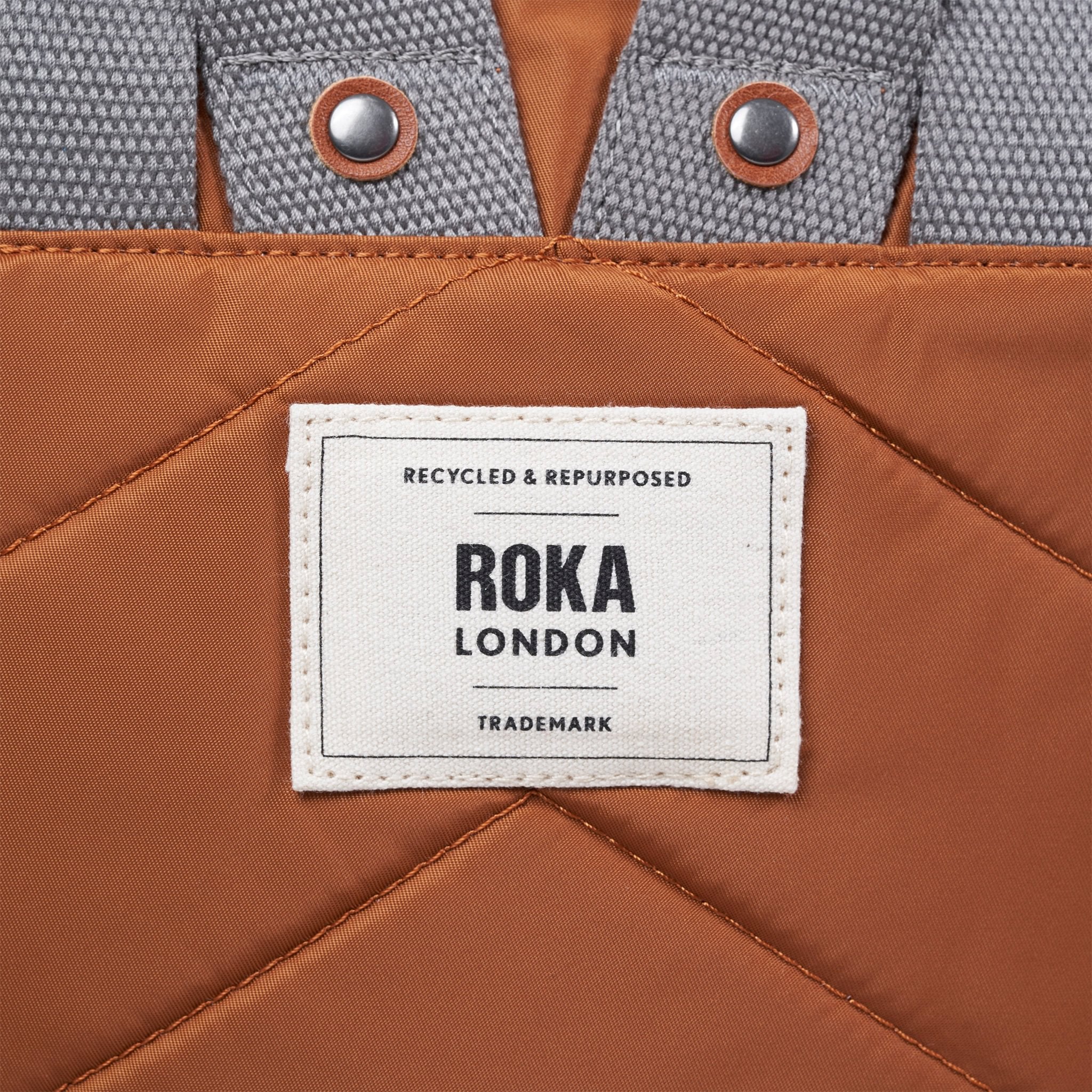 Roka Canfield Medium Bran Recycled Nylon Backpack, brand label detail.