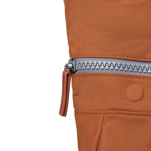Roka Canfield Medium Bran Recycled Nylon Backpack, zip detail.