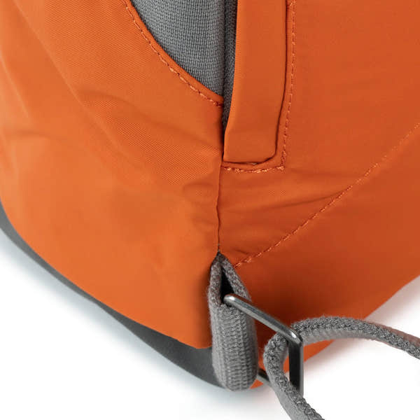 Roka Canfield Medium Burnt Orange Recycled Nylon Backpack, hardware detail.