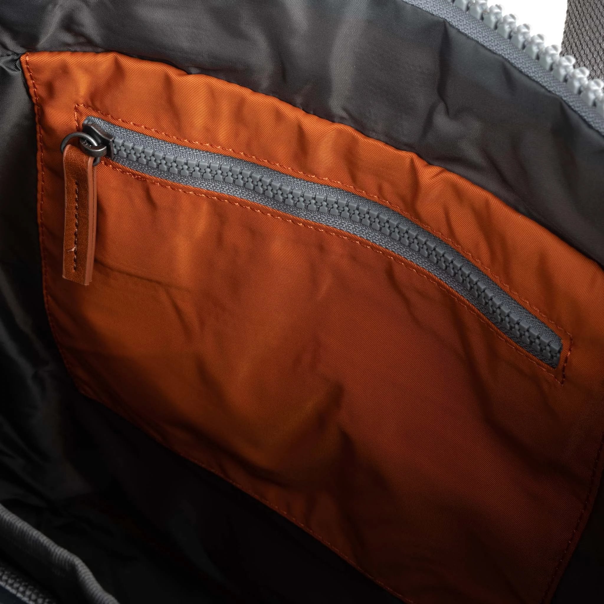 Roka Canfield Medium Burnt Orange Recycled Nylon Backpack, interior view.