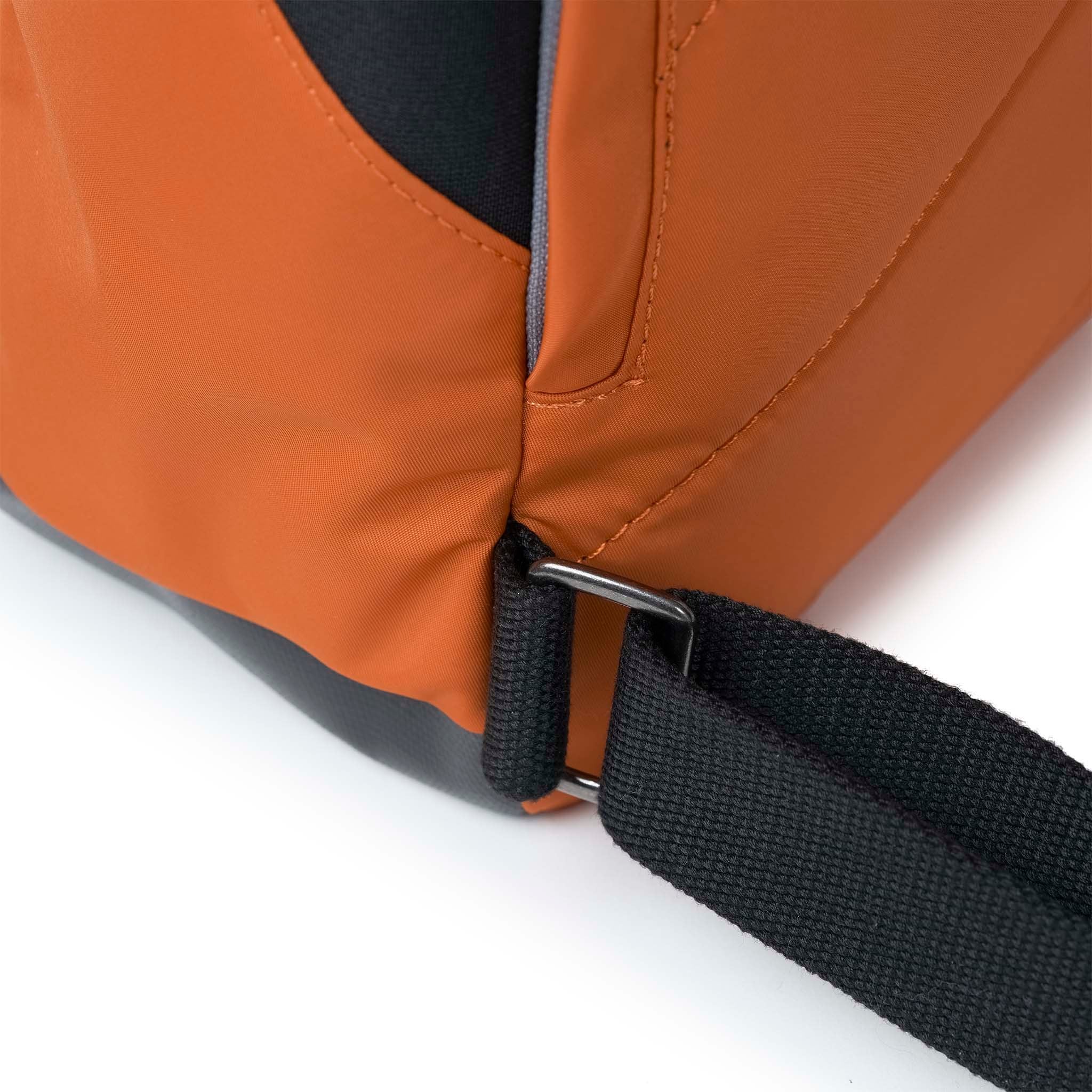Roka Canfield Medium Burnt Orange Recycled Nylon Backpack, strap detail.
