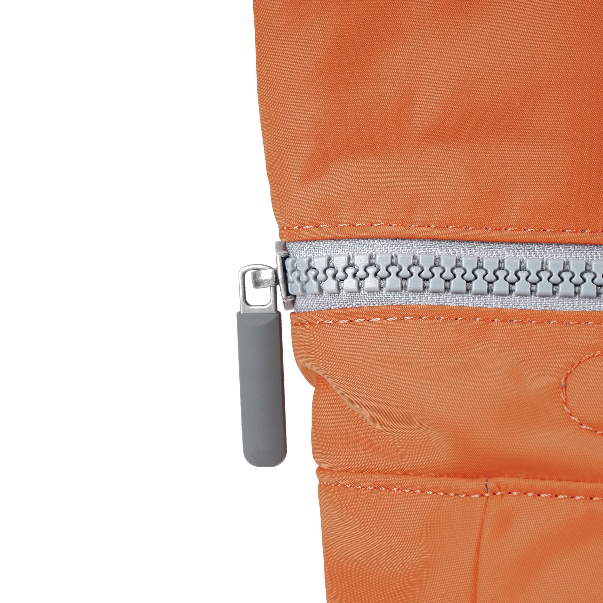 Roka Canfield Medium Burnt Orange Recycled Nylon Backpack, zip detail.