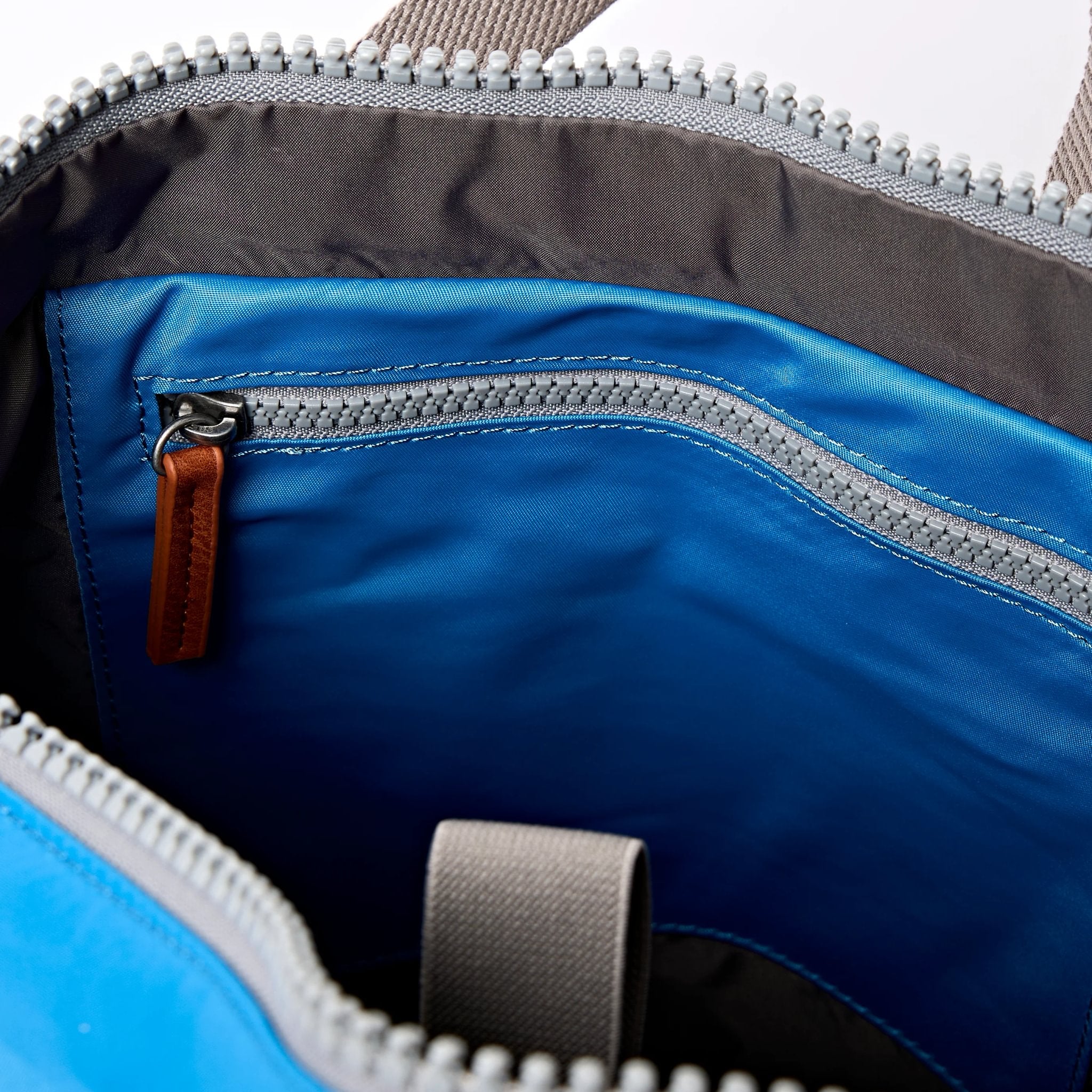 Roka Canfield Medium Malibu Blue Recycled Nylon Backpack, side view.