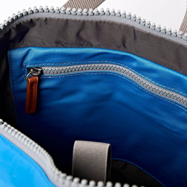 Roka Canfield Medium Malibu Blue Recycled Nylon Backpack, side view.