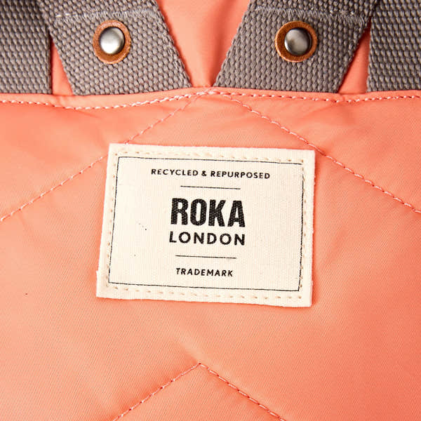 Roka Canfield Medium Sugar Coral Recycled Nylon Backpack, brand label detail.