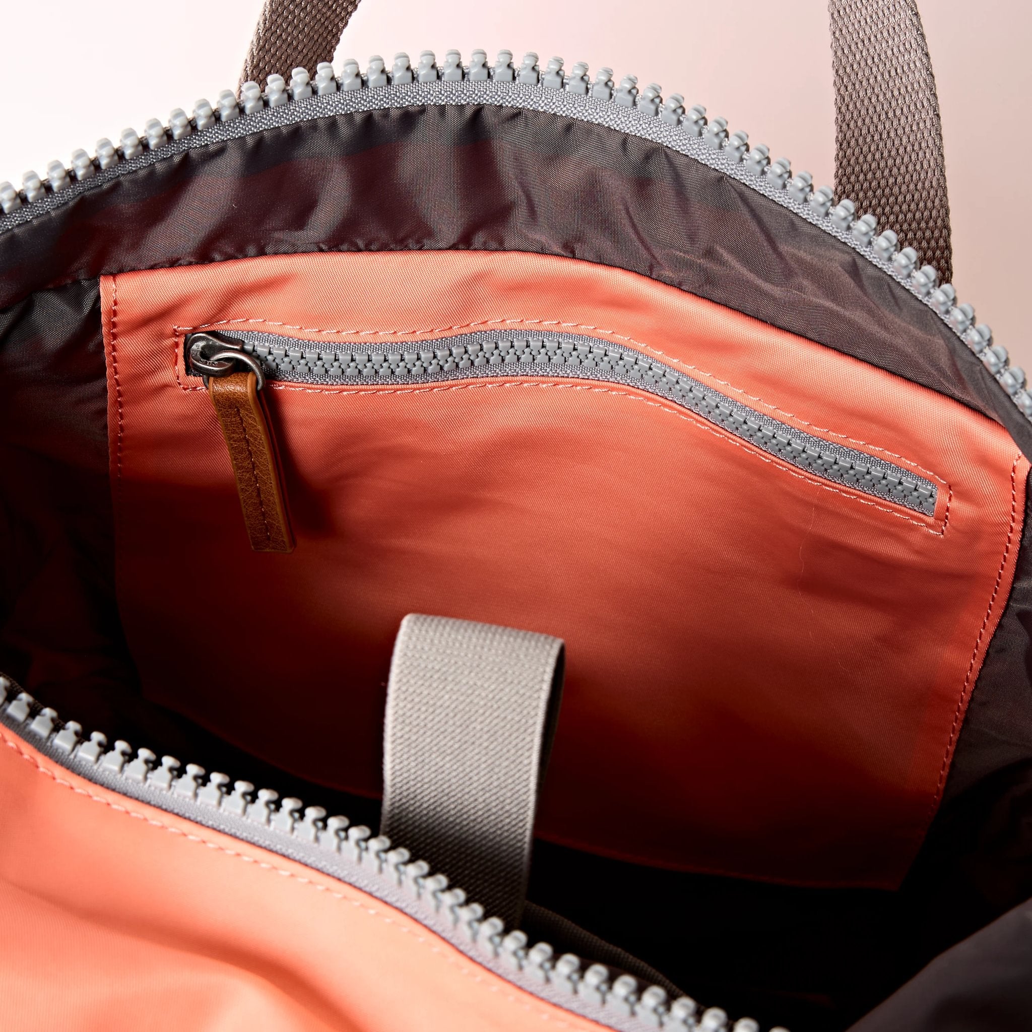 Roka Canfield Medium Sugar Coral Recycled Nylon Backpack, side view.