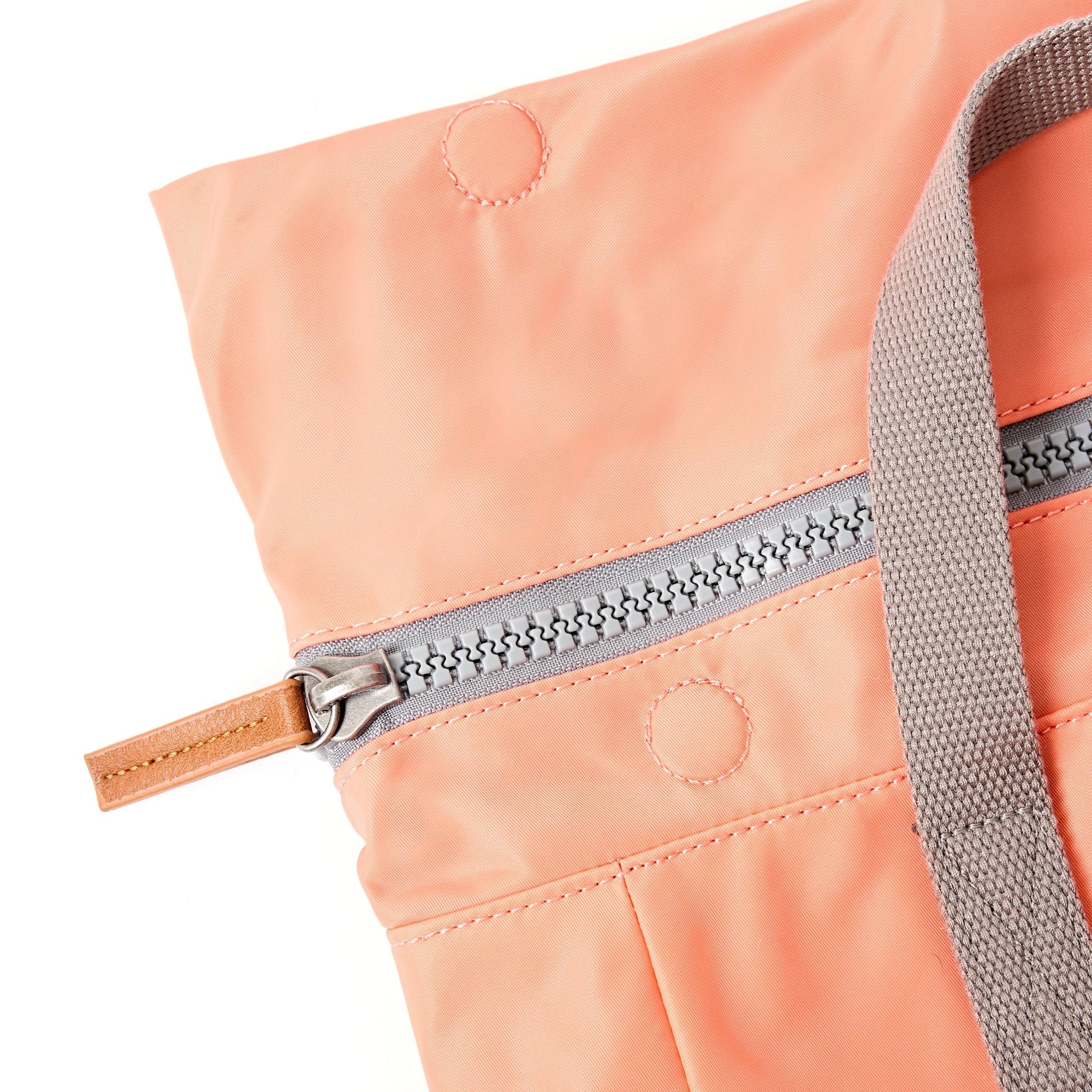 Roka Canfield Medium Sugar Coral Recycled Nylon Backpack, zip detail.