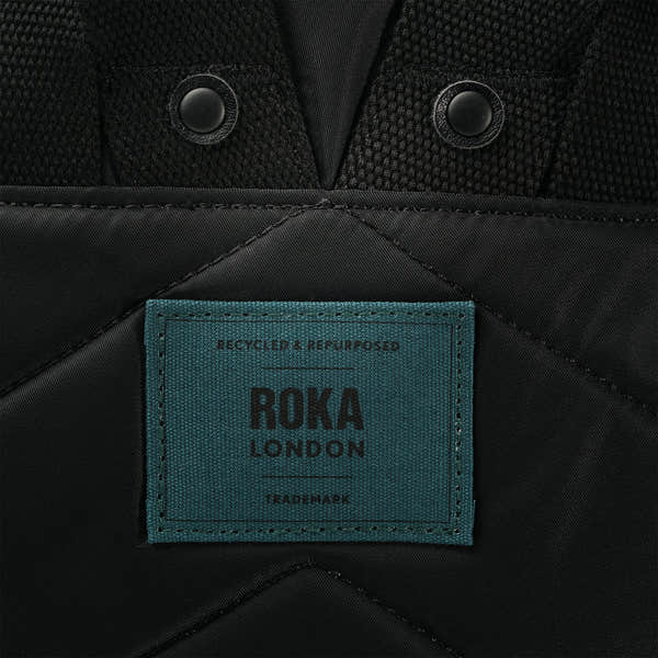 Roka Canfield Medium Teal Recycled Nylon Backpack, brand label detail.