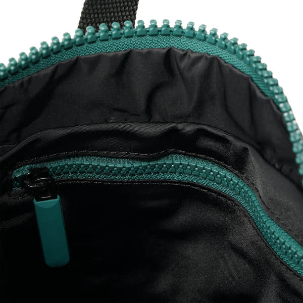 Roka Canfield Medium Teal Recycled Nylon Backpack, side view.