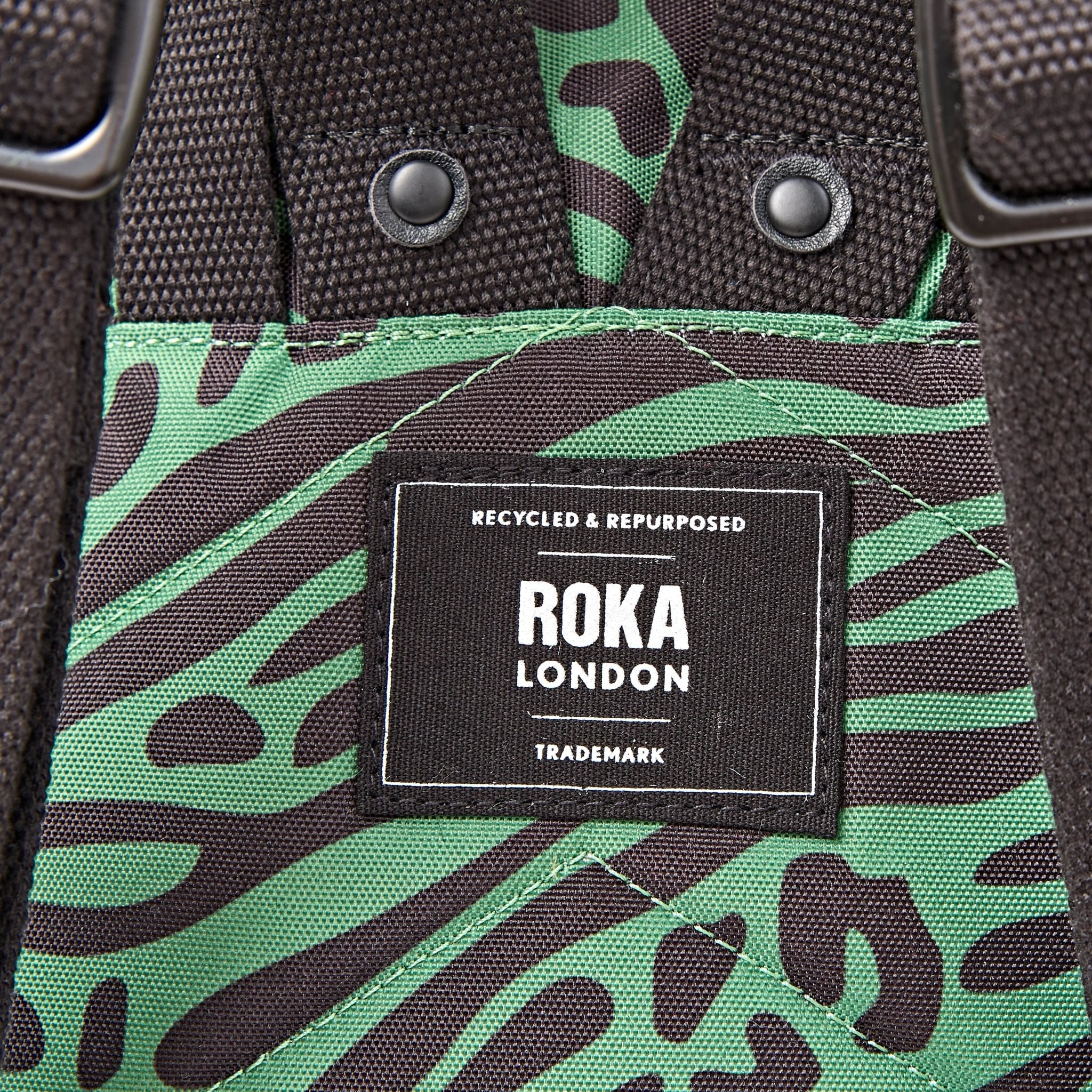 Roka Canfield Small Mixed Animal Artichoke Recycled Canvas Backpack, brand label detail.