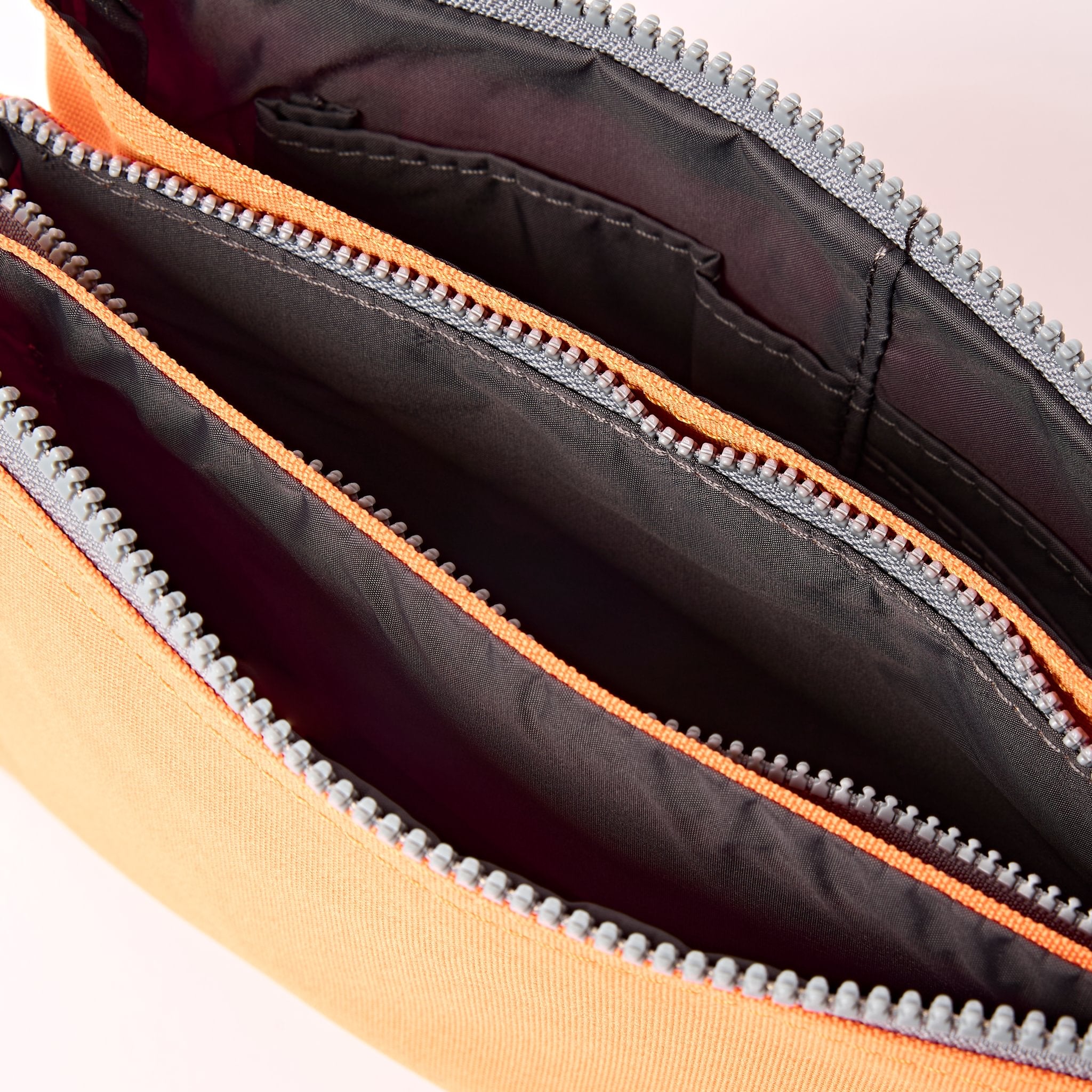 Roka Carnaby XL Jaffa Orange Recycled Canvas Crossbody Bag, side view.