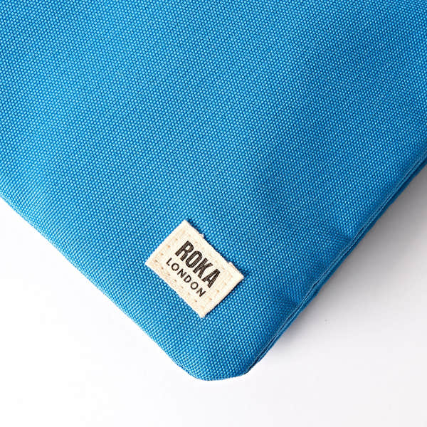 Roka Carnaby XL Malibu Blue Recycled Canvas Crossbody Bag, brand label detail.