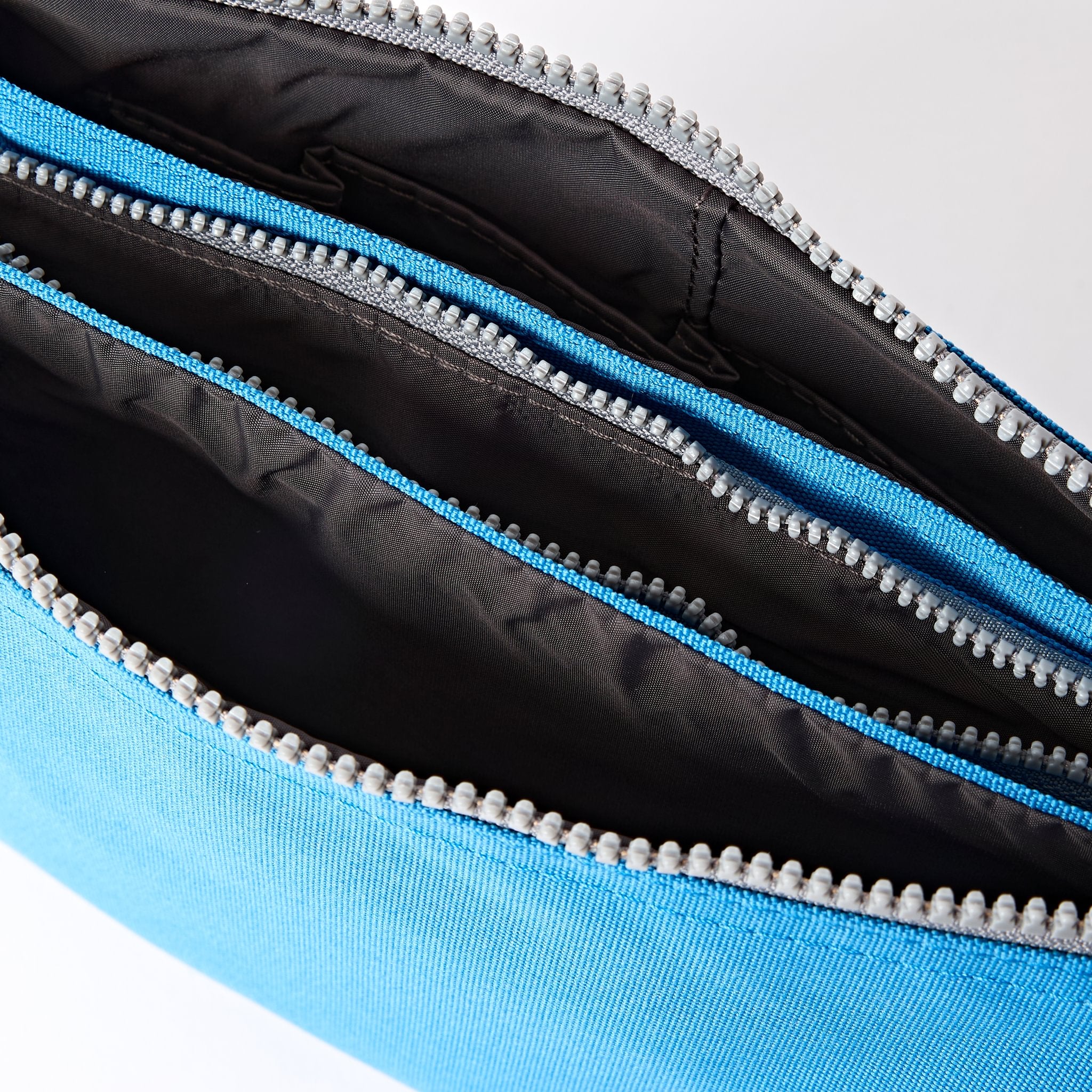 Roka Carnaby XL Malibu Blue Recycled Canvas Crossbody Bag, side view.