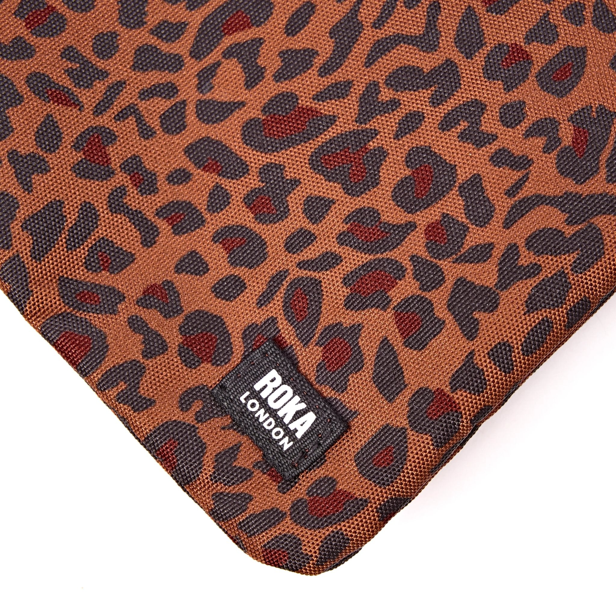 Roka Carnaby XL Mini Leopard Recycled Canvas Crossbody Bag, brand label detail.