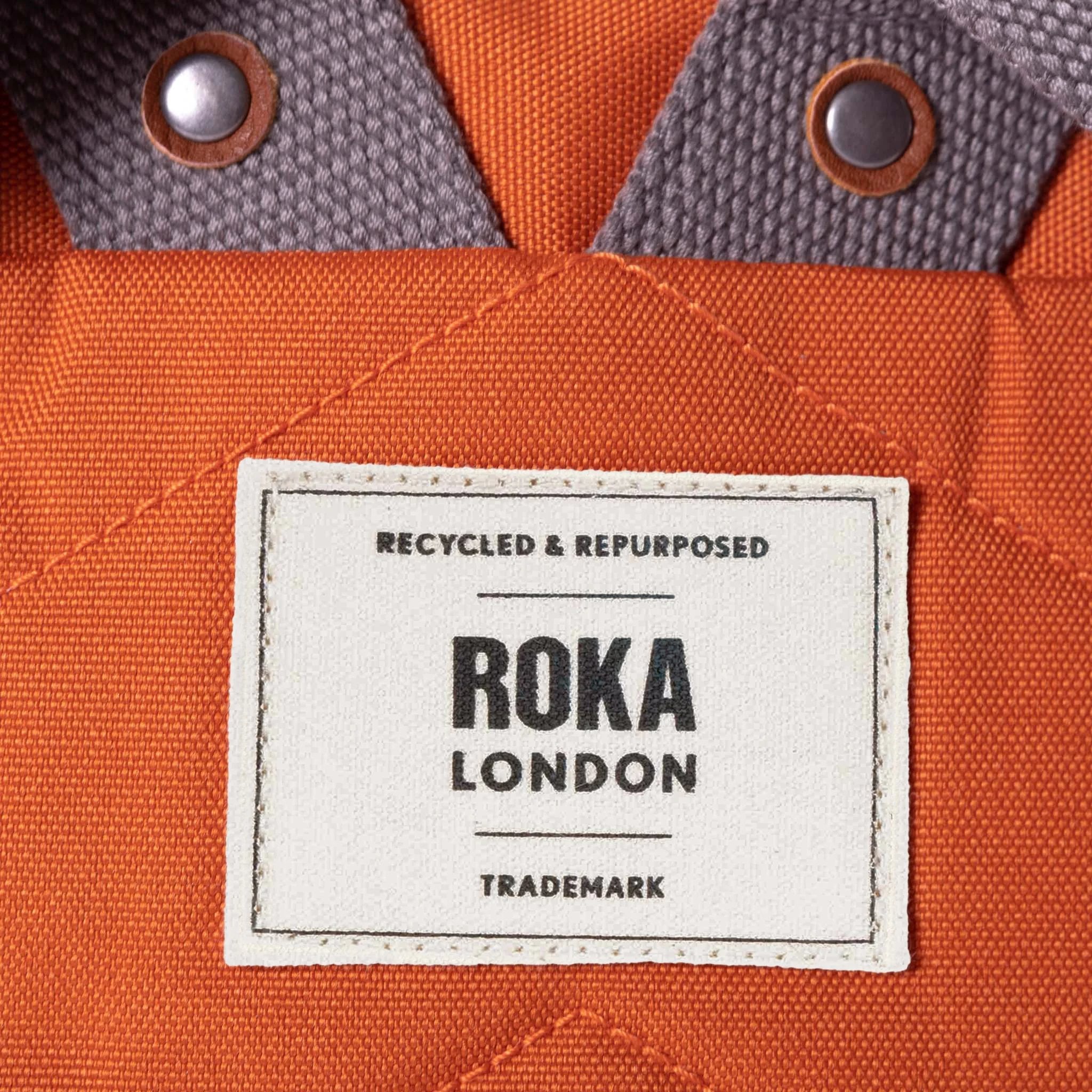 Roka Finchley A Atomic Orange Recycled Canvas, brand label detail.