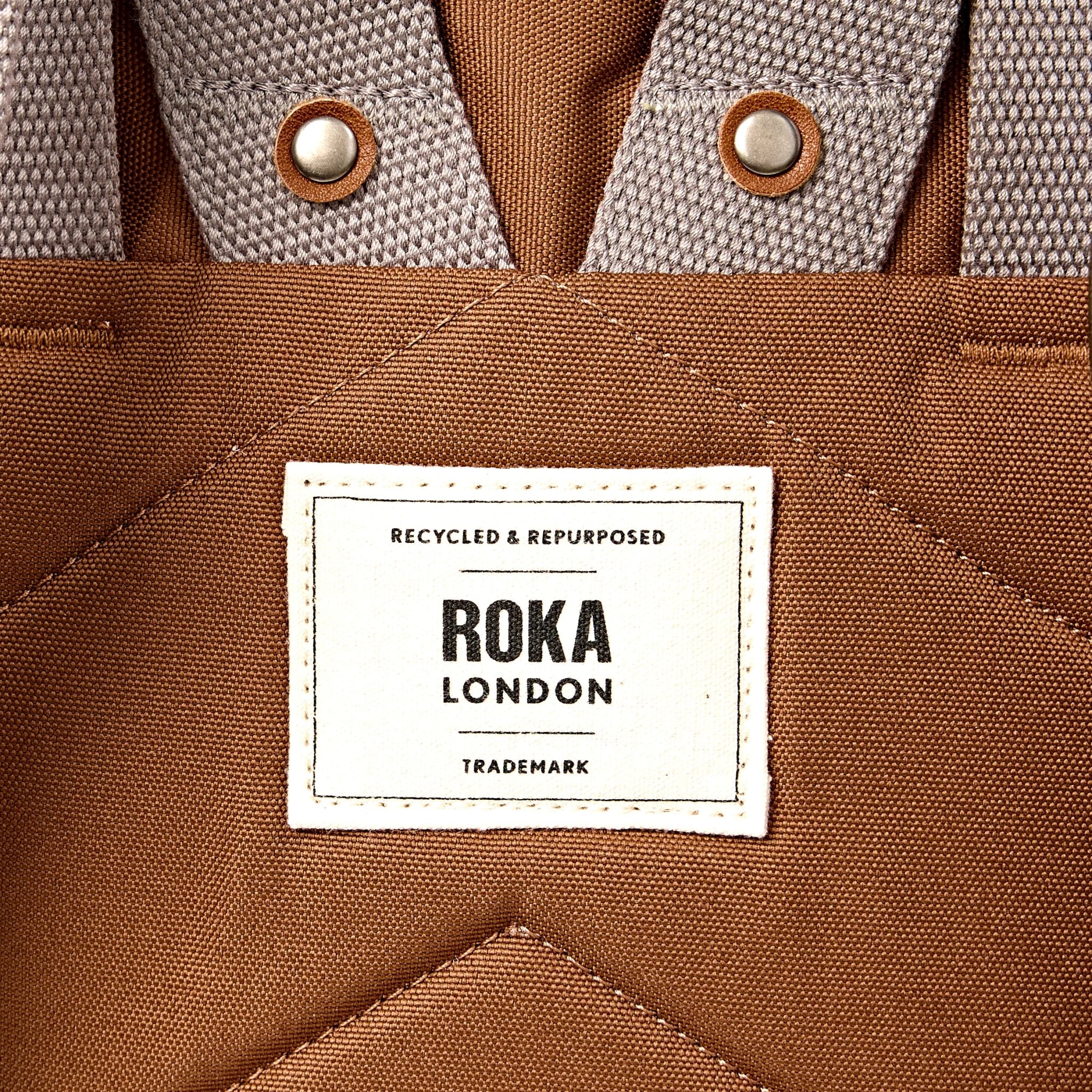 Roka Finchley Medium Cinnamon Recycled Canvas Backpack, brand label detail.