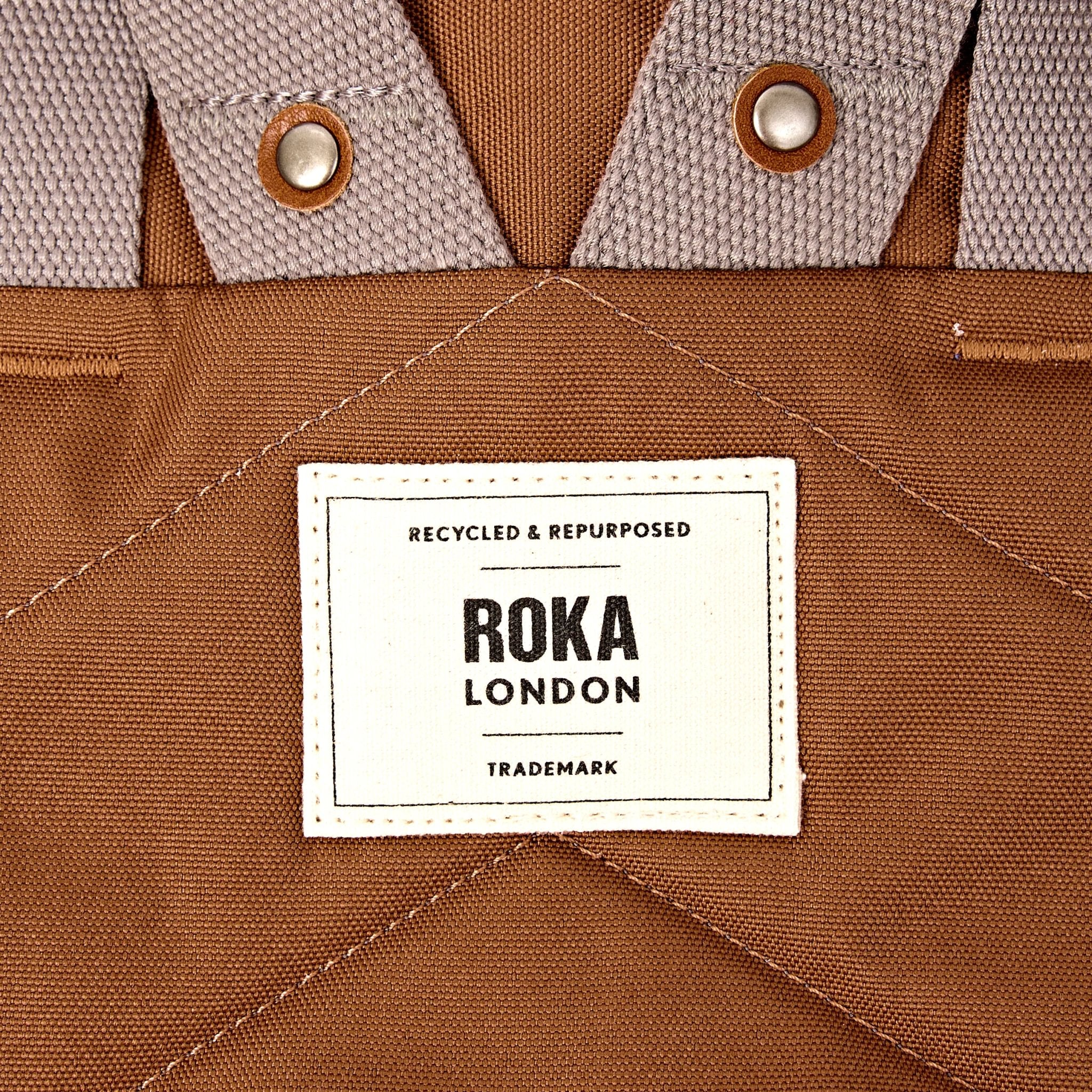 Roka Finchley Small Cinnamon Recycled Canvas Backpack, brand label detail.