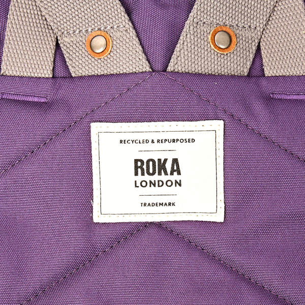 Roka Finchley Small Deep Grape Recycled Canvas Backpack, brand label detail.