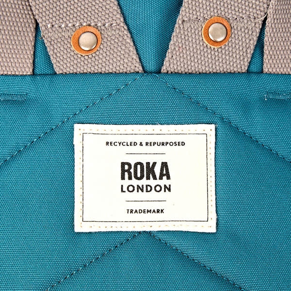 Roka Finchley Small Deep Teal Recycled Canvas Backpack, brand label detail.