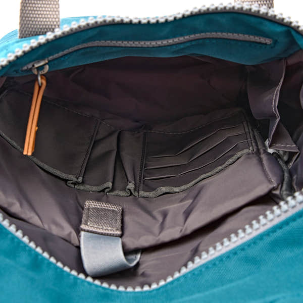 Roka Finchley Small Deep Teal Recycled Canvas Backpack, side view.