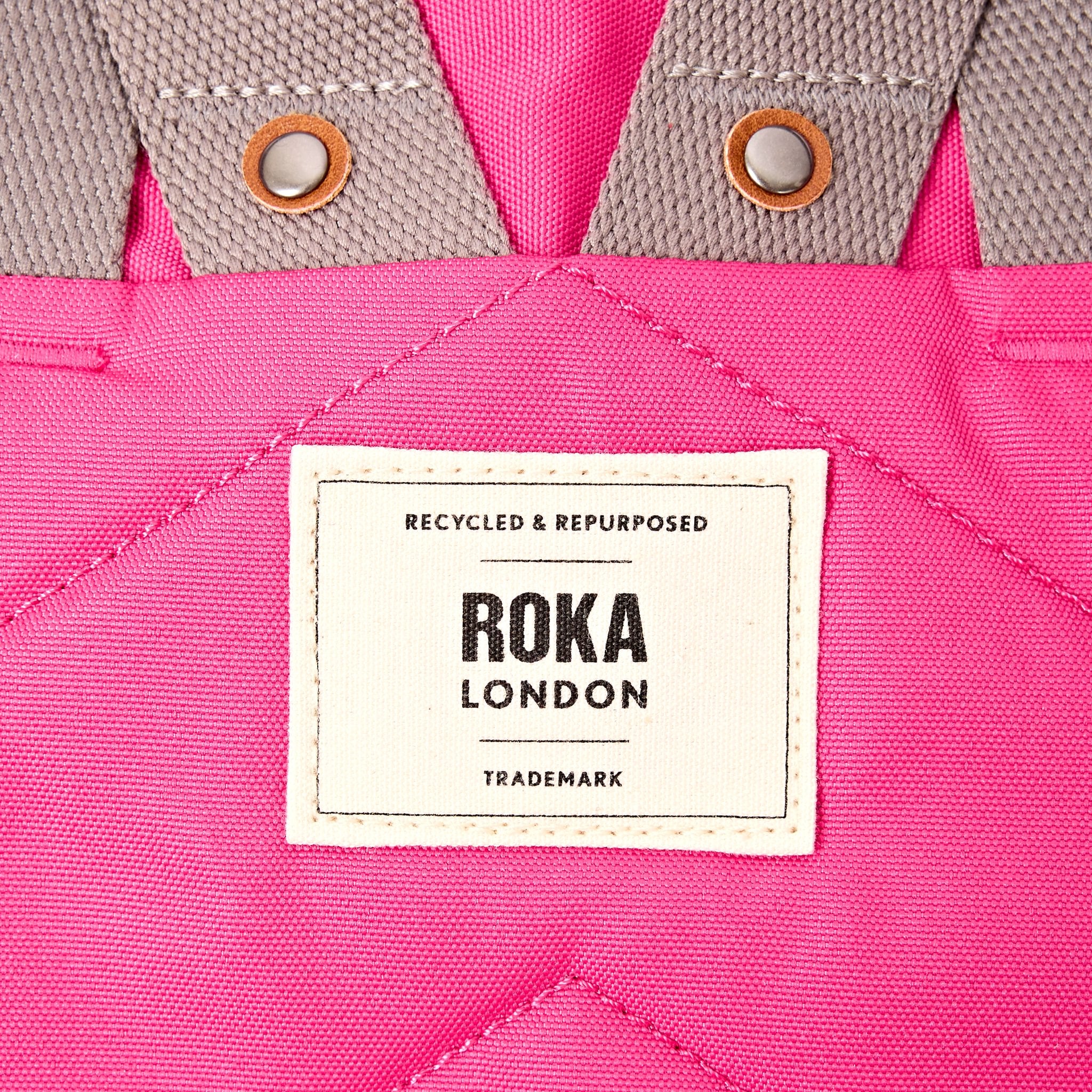 Roka Finchley Small Granita Red Recycled Canvas Backpack, brand label detail.