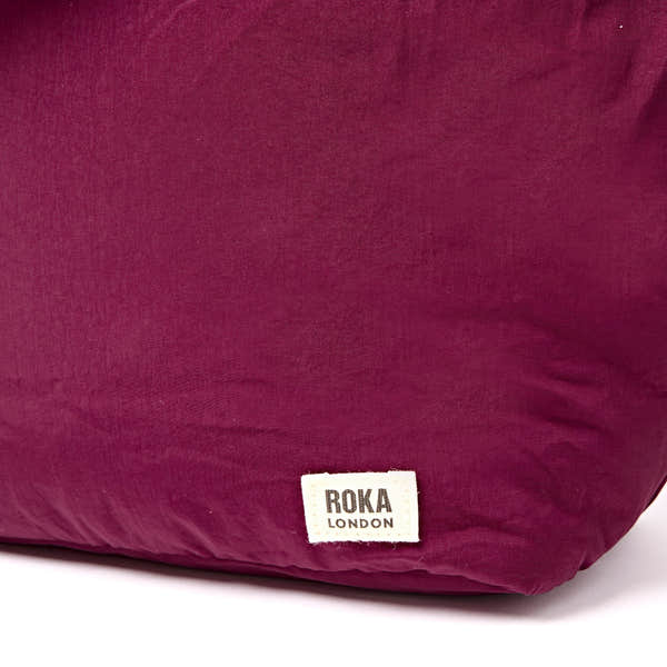 Roka Oxford Merlot Recycled Taslon Shoulder Bag, brand label detail.
