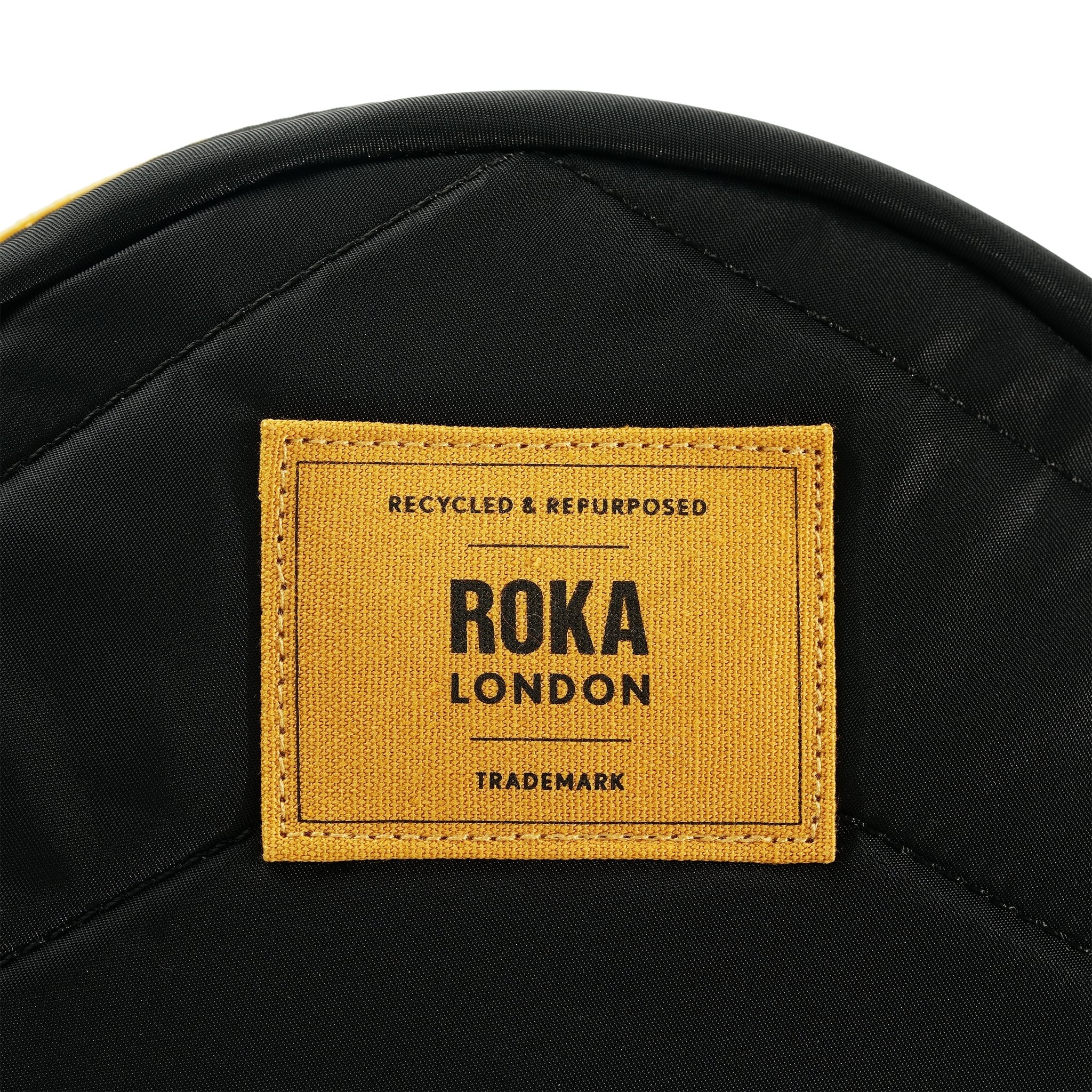 Roka Paddington Corn Recycled Nylon Crossbody Bag, brand label detail.