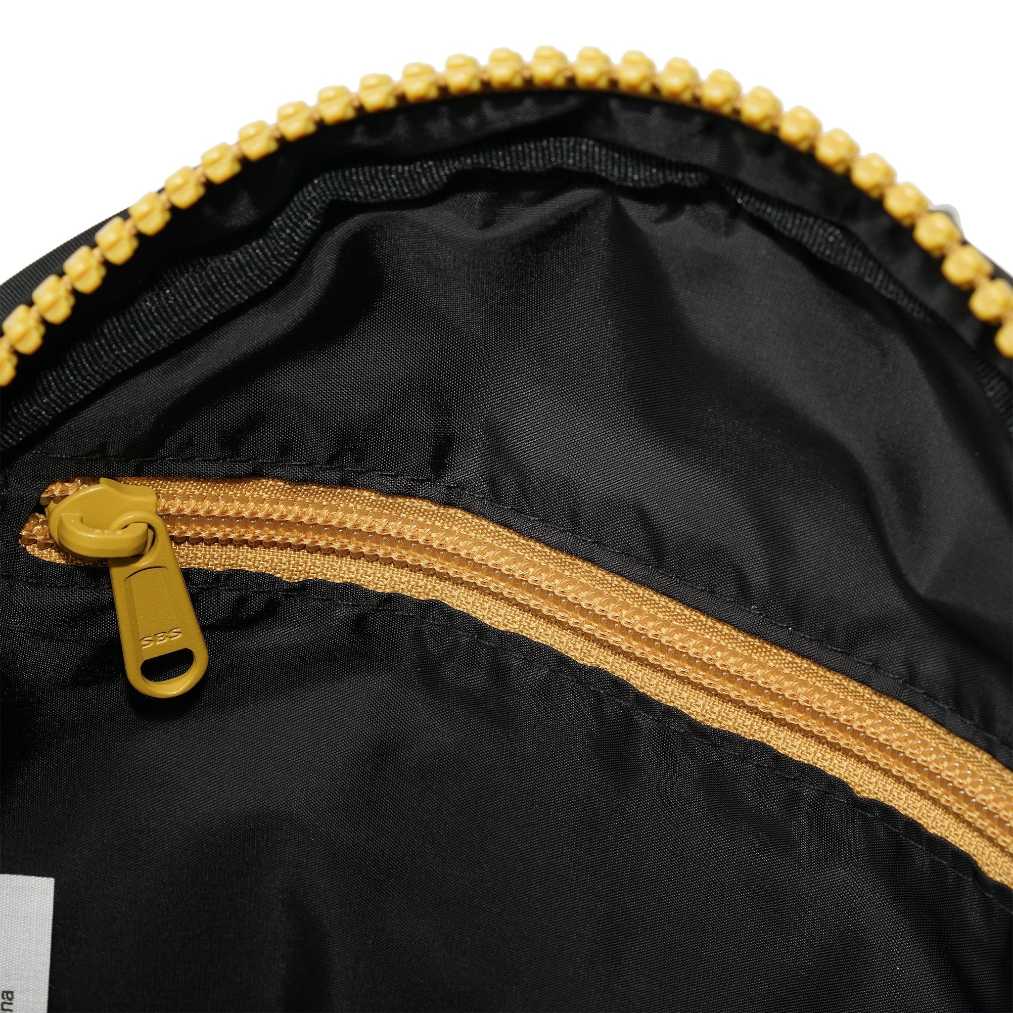 Roka Paddington Corn Recycled Nylon Crossbody Bag, side view.
