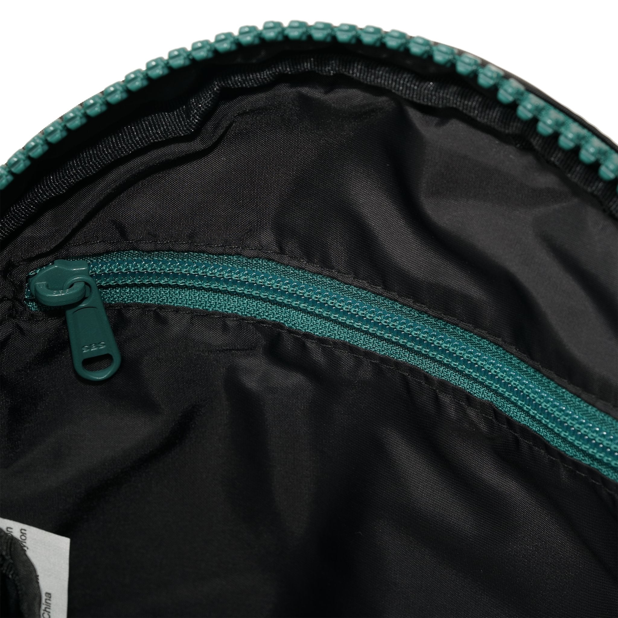 Roka Paddington Teal Recycled Nylon Crossbody Bag, side view.