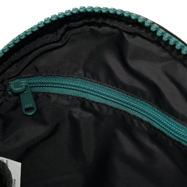 Roka Paddington Teal Recycled Nylon Crossbody Bag, side view.