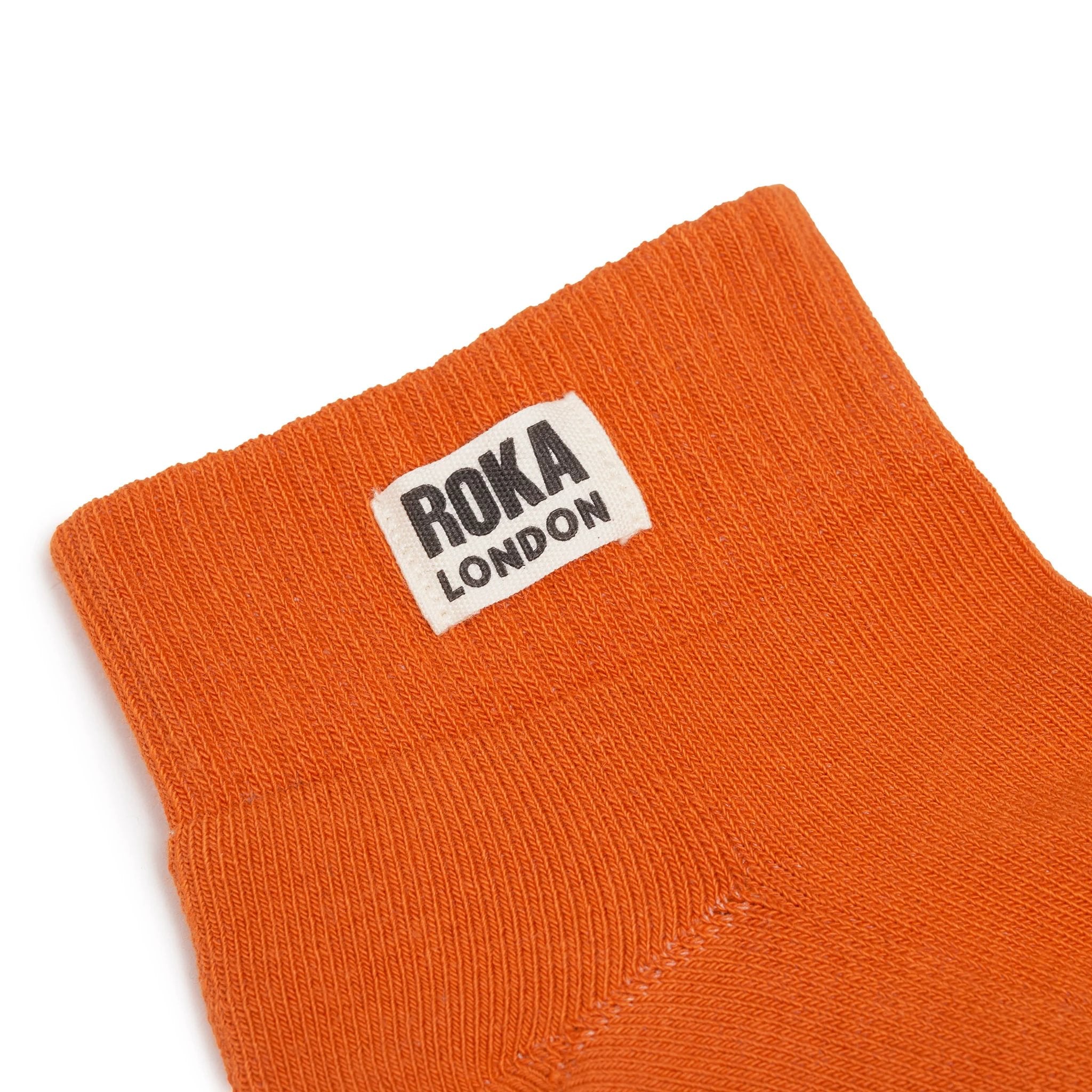 Roka Wembley Burnt Orange Organic Cotton One Size, brand label detail.