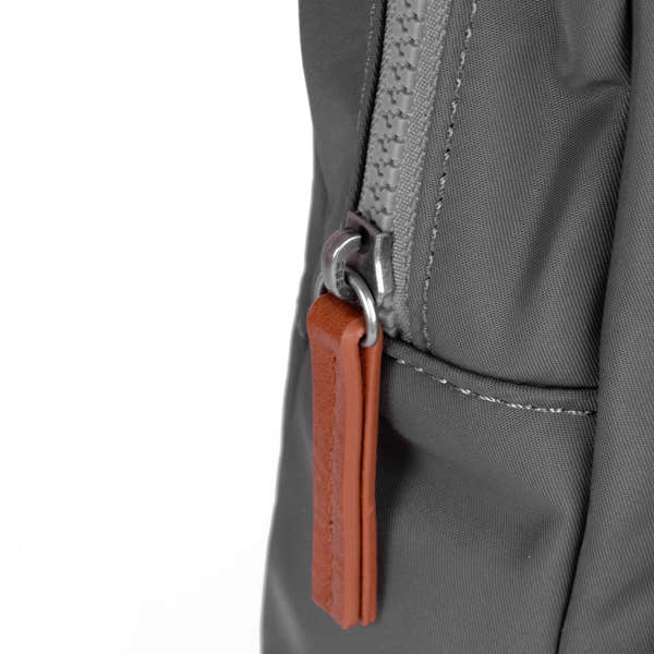 Roka Willesden Graphite Recycled Nylon Sling Bag, zip detail.
