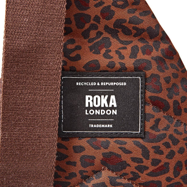 Roka Willesden Mini Leopard Recycled Canvas Sling Bag, brand label detail.