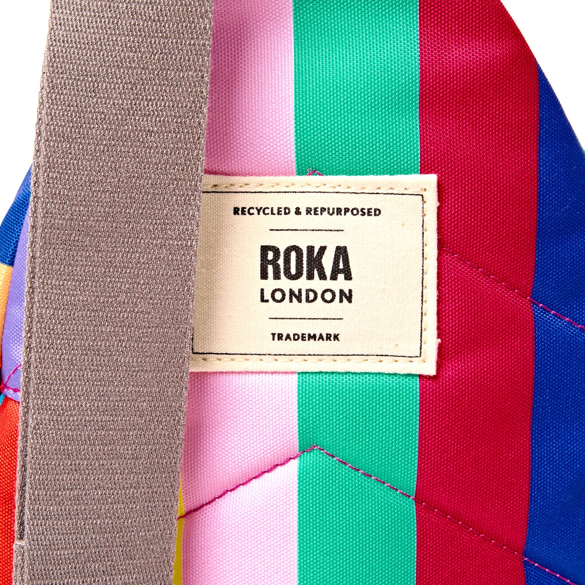 Roka Willesden Wide Multi Stripe Recycled Canvas Sling Bag, brand label detail.