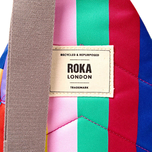 Roka Willesden Wide Multi Stripe Recycled Canvas Sling Bag, brand label detail.
