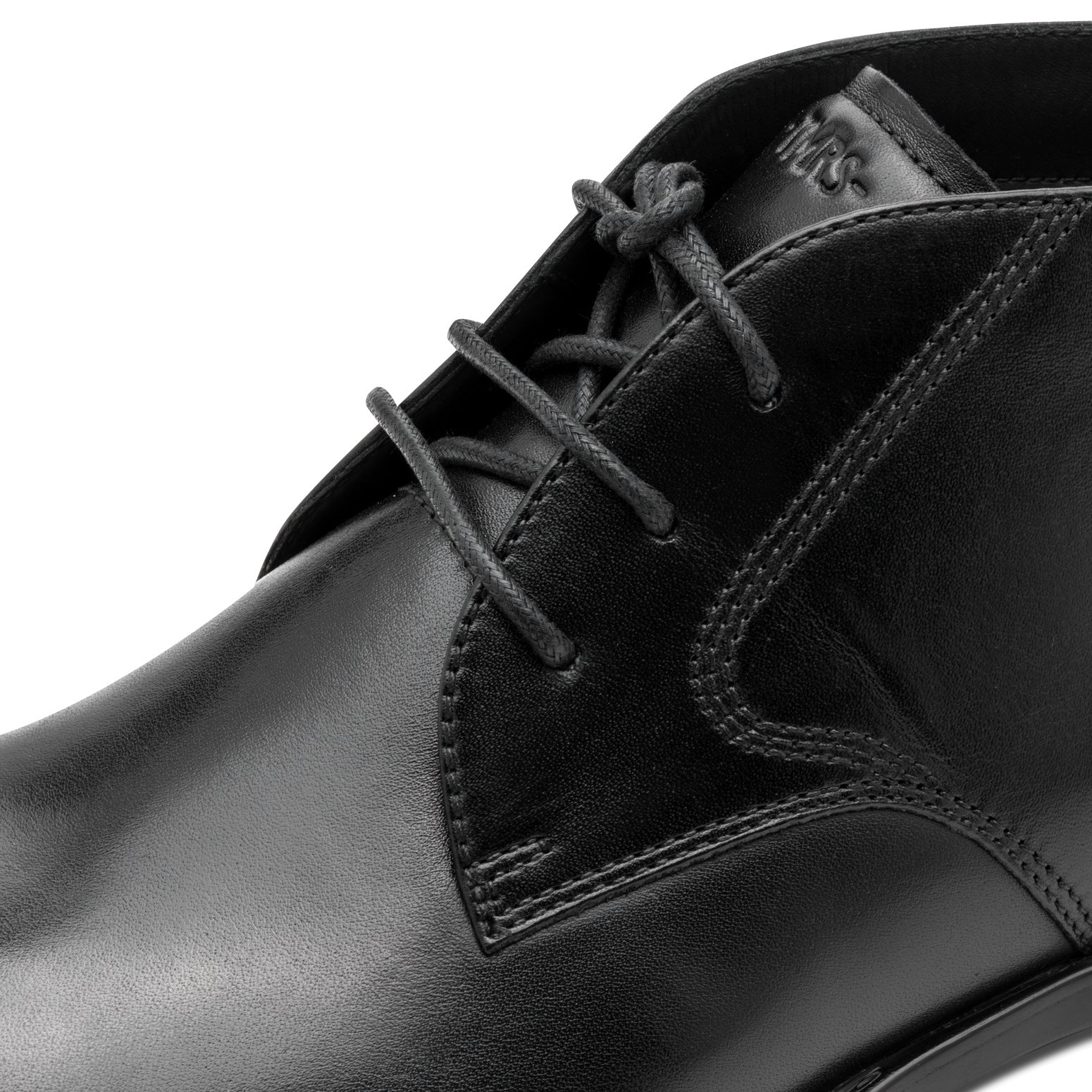 Close-up of the black Tamaris chukka boot showing the leather upper, stitching and lace eyelets.