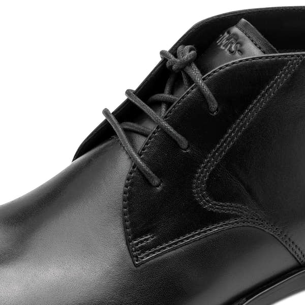 Close-up of the black Tamaris chukka boot showing the leather upper, stitching and lace eyelets.