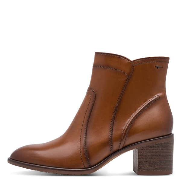 Outer side of the cognac Tamaris ankle boot showing the stitched leather panels and block heel.