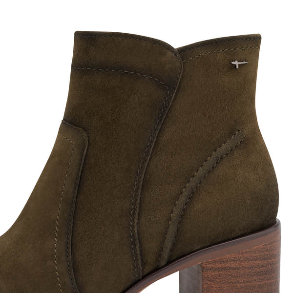 Close-up of the olive suede Tamaris ankle boot showing the suede leather panels, stitching, Tamaris trim and block heel.