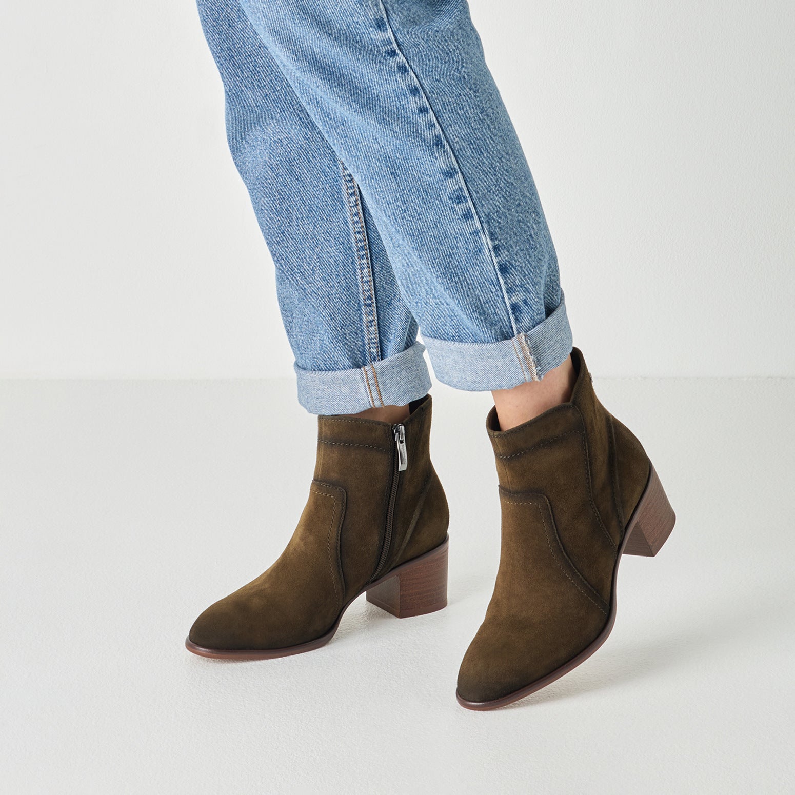 Olive suede tamaris ankle boot worn on foot, side view.