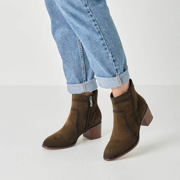Olive suede tamaris ankle boot worn on foot, side view.