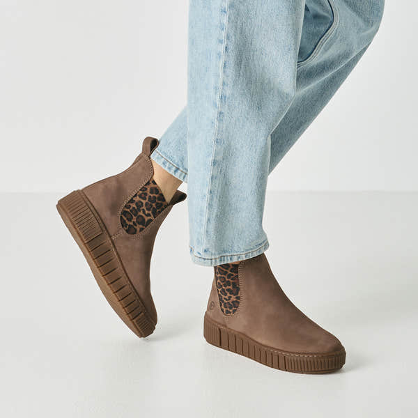 Taupe leopard tamaris chelsea boot worn on foot, side view.