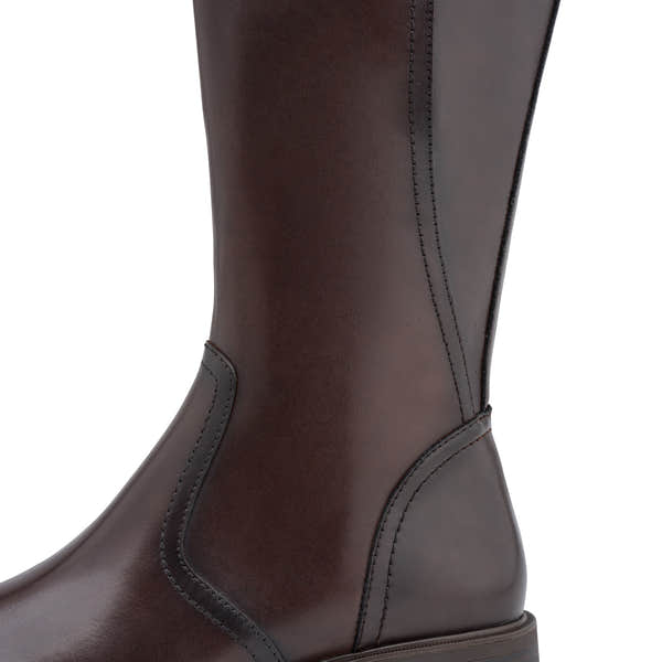Close-up of the mahogany brown Tamaris knee-high boot showing the mixed leather panels, stitching and heel.