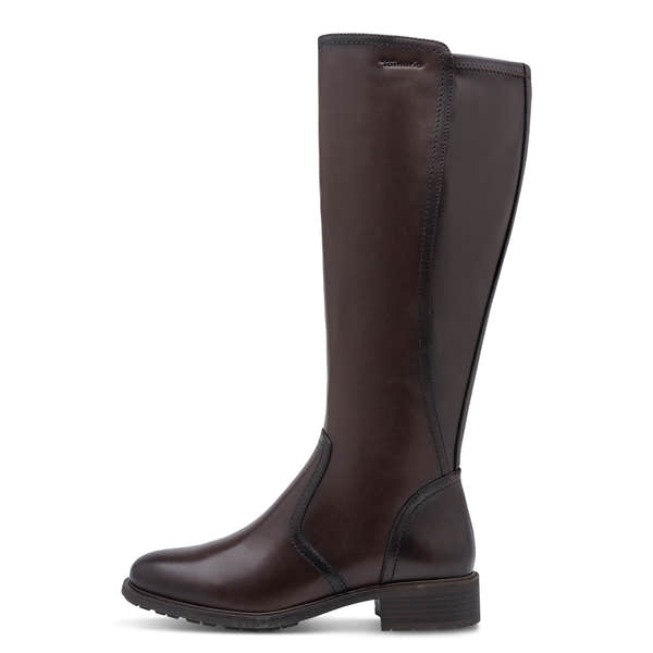 Outer side of the mahogany brown Tamaris knee-high boot showing the mixed leather shaft panels and heel.