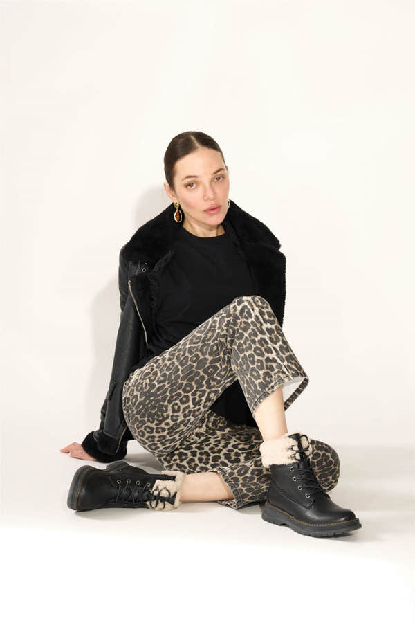 Westland Peyton 16 women's black vegan waterproof zip-and-lace faux fur ankle boots worn on foot, Westland lifestyle view 14.